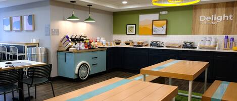 A modern cafe with wooden tables and chairs, a counter with food items, and a sign that reads "Delight in the day".