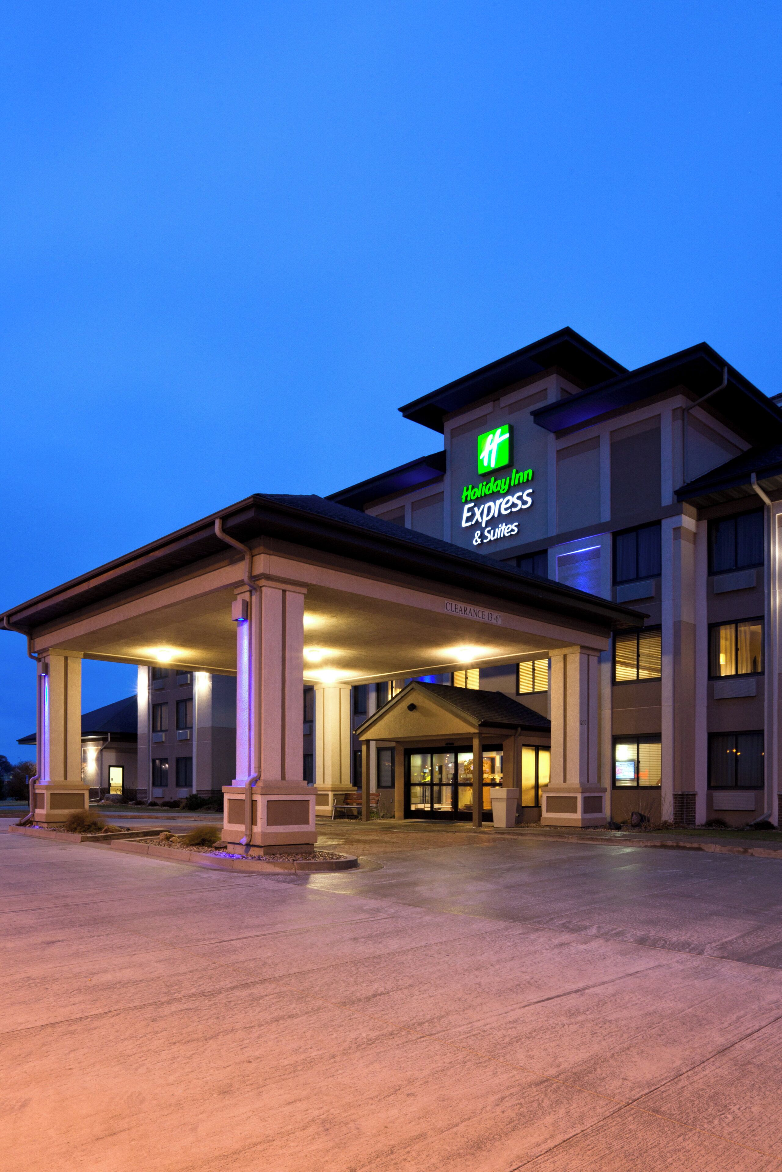 A Holiday Inn Express building with a covered entrance and a sign indicating 'Clearance 13'-6' for vehicle access.