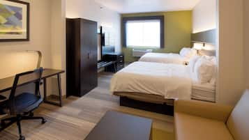 A hotel room with two beds, a desk, a chair, a couch, and a large window.