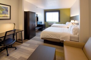 A hotel room with two beds, a desk, a chair, a couch, and a large window.