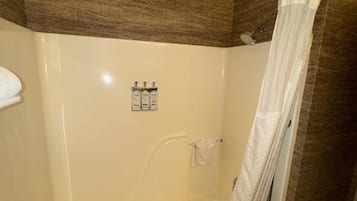 A bathroom with a bathtub, a shower curtain, and a towel rack.