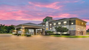 A Holiday Inn Express hotel with a covered parking area and a two-story building.