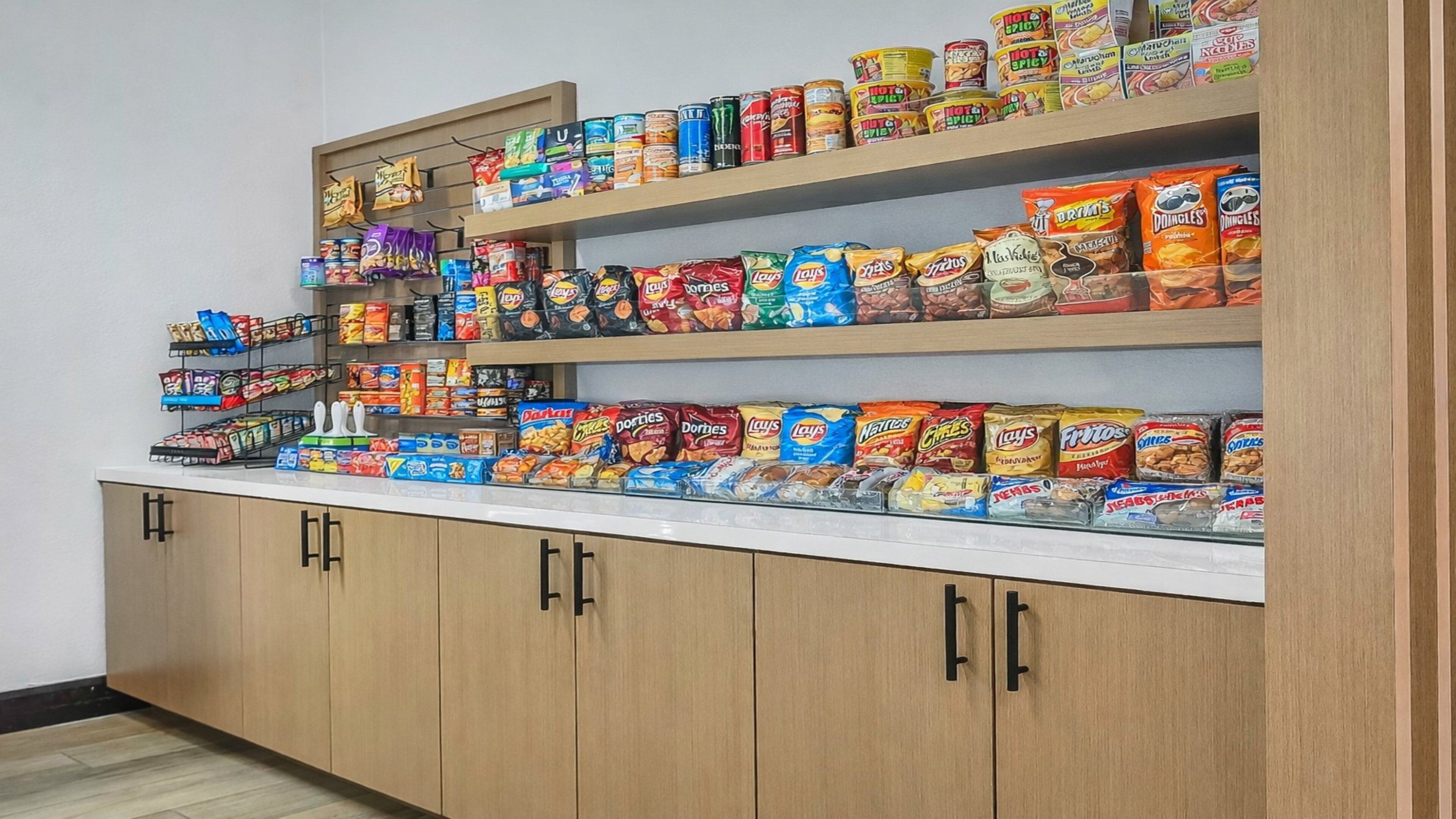 A snack display with various brands and types of chips and snacks.