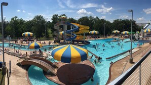 A water park with multiple pools, slides, and umbrellas. - Holiday Inn Express & Suites Batesville by IHG (Batesville)