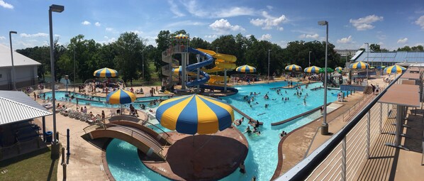 A water park with multiple pools, slides, and umbrellas. - Holiday Inn Express & Suites Batesville by IHG (Batesville)