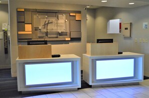 A reception desk area with a sign for Holiday Inn Express & Suites. - Holiday Inn Express & Suites Batesville by IHG (Batesville)