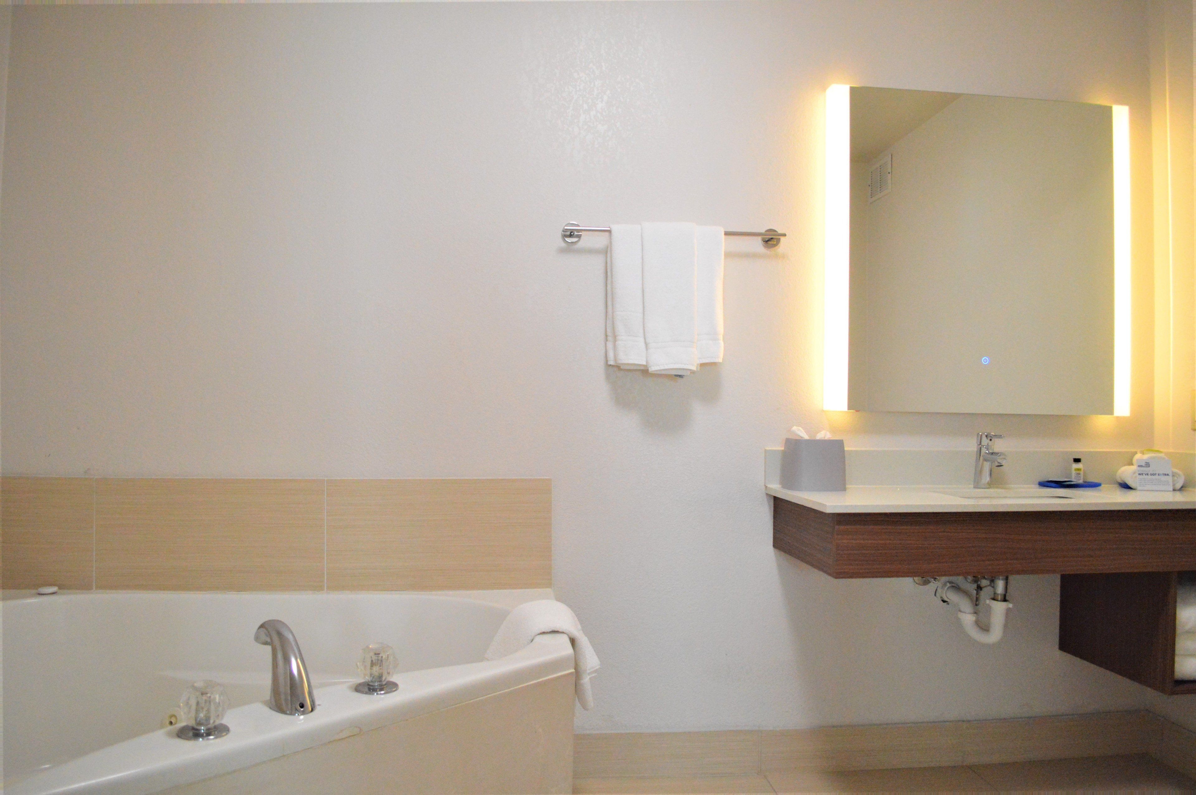 suite, 1 bedroom, jetted tub (1 king, sofa bed) | bathroom | combined shower/bathtub, rainfall showerhead, free toiletries