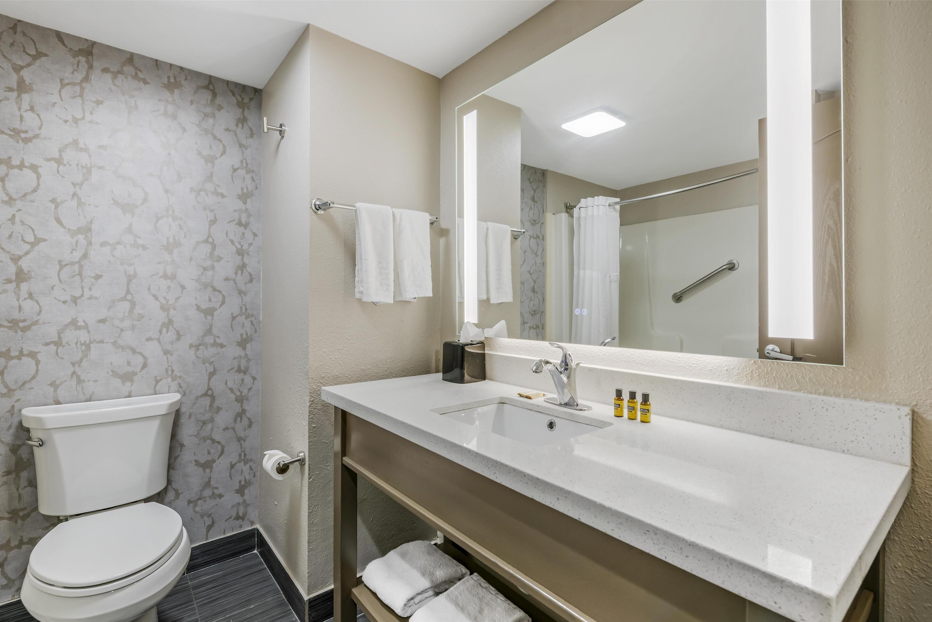 junior suite, 1 king bed, non smoking, refrigerator & microwave | bathroom | free toiletries, hair dryer, towels