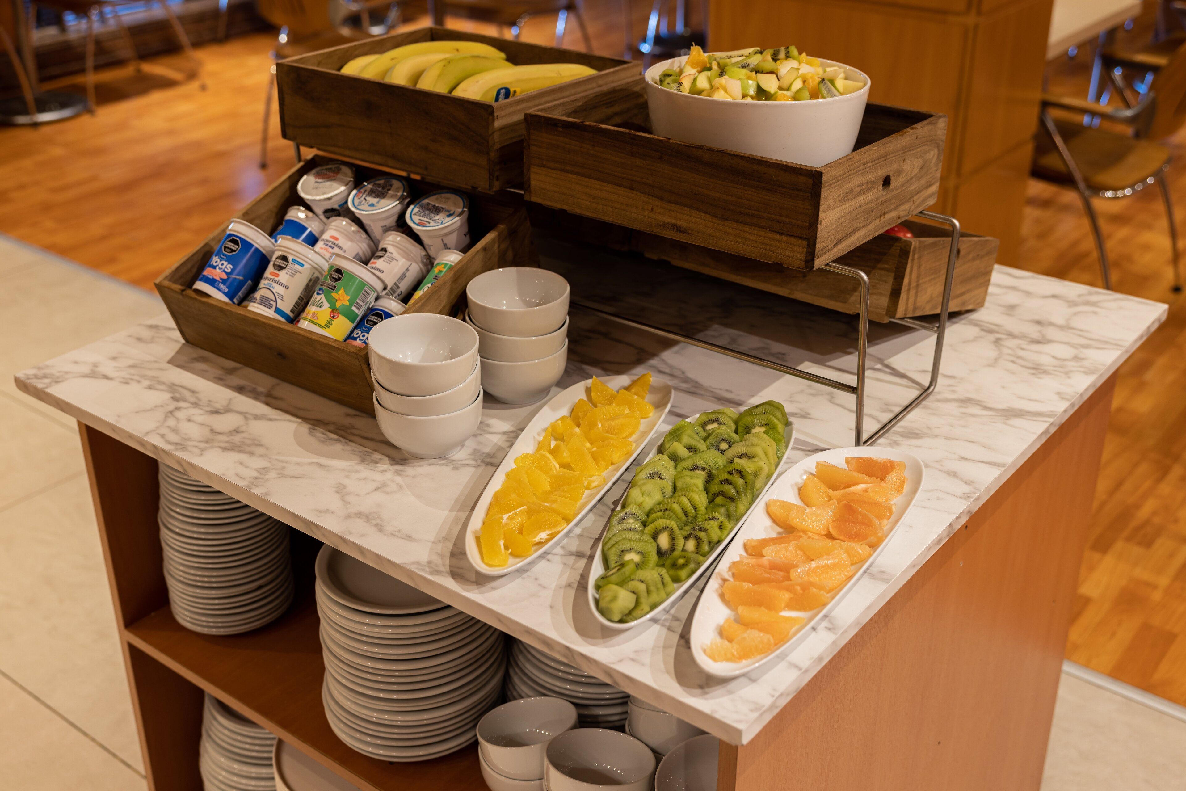 A buffet with various fruits and beverages.