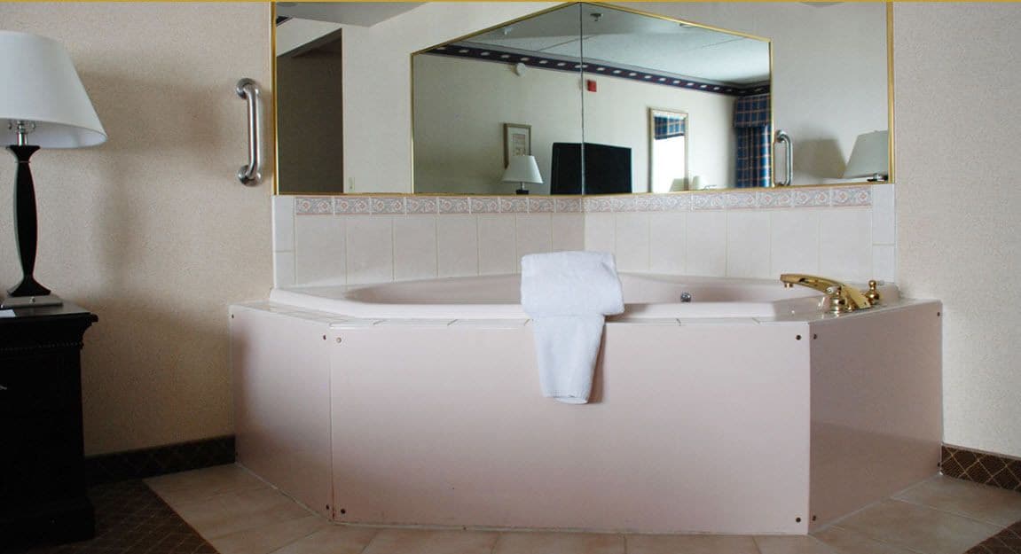 room, 1 king bed, jetted tub (not pet friendly) | blackout curtains, iron/ironing board, free cots/infant beds