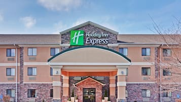 A Holiday Inn Express building with a brick facade, large windows, and a prominent entrance.