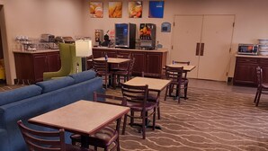 A hotel lobby with a seating area, a kitchenette, and a reception desk. - Comfort Inn & Suites Dayville - Killingly Industrial Park (Dayville)