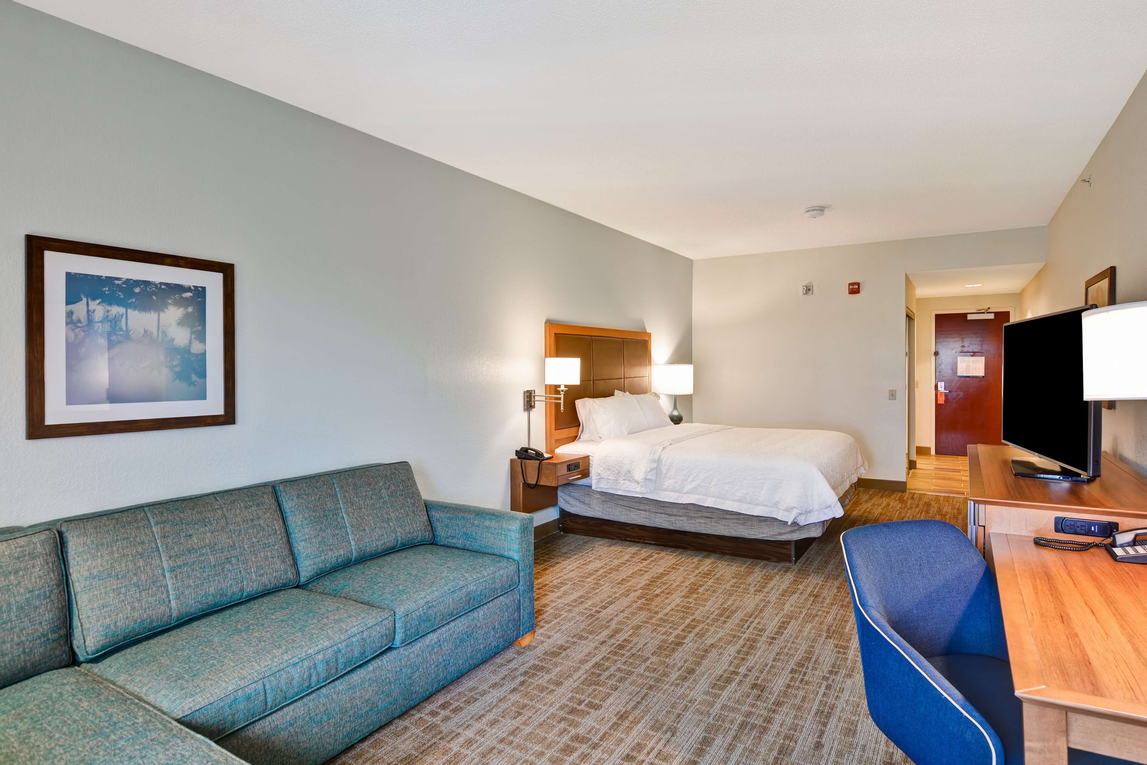 Premium bedding, laptop workspace, iron/ironing board