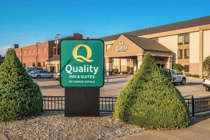 A Quality Inn & Suites sign in front of a hotel building.