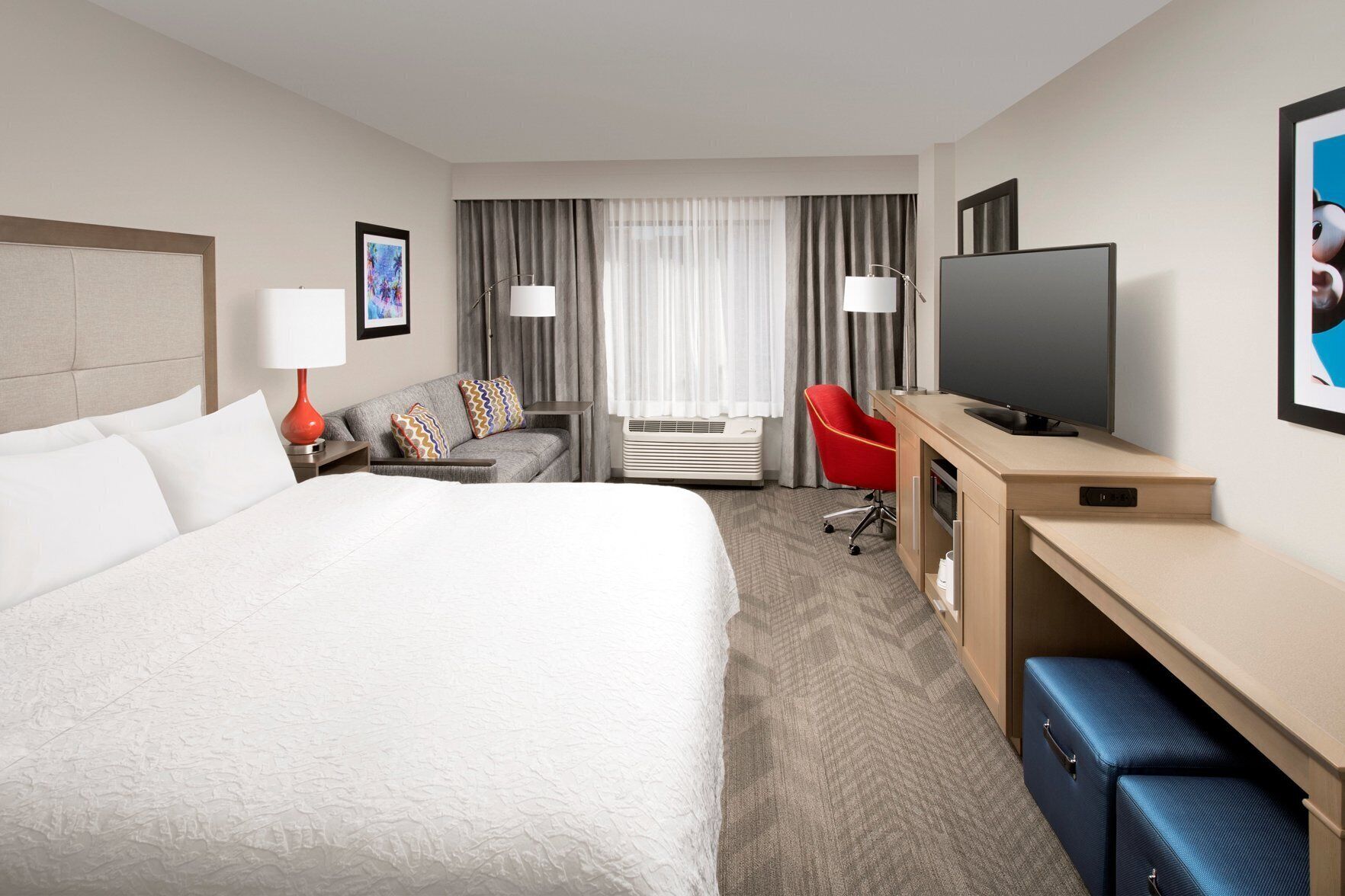 Premium bedding, desk, laptop workspace, blackout drapes