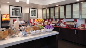 A buffet setup with various food items and beverages.