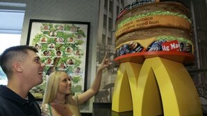A McDonald's display with a sesame seed bun and lettuce.