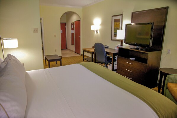 A hotel room with a large bed, a desk with a computer, a TV, and a chair. - Holiday Inn Express & Suites Houston North Intercontinental by IHG (Houston)