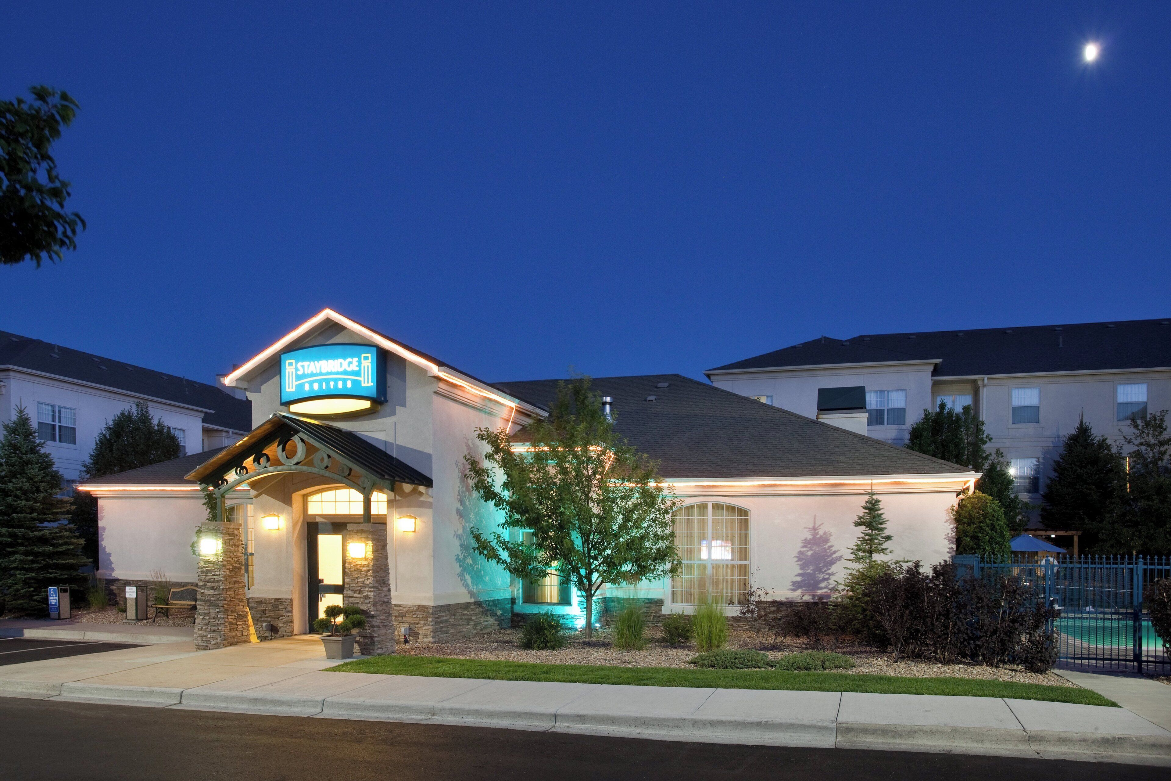 A hotel with a sign reading 'Staybridge' and a well-lit entrance.
