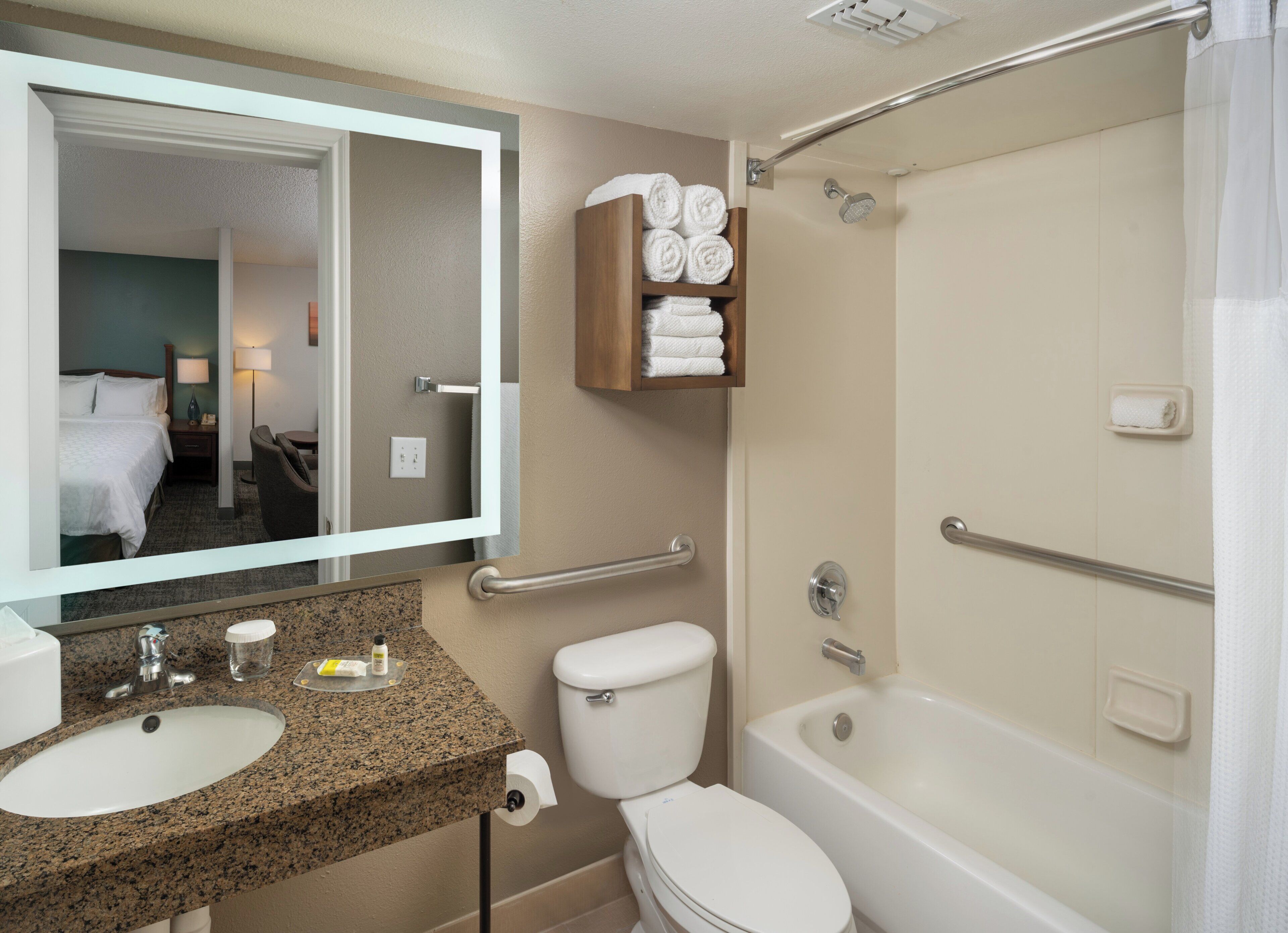 A bathroom with a sink, toilet, and bathtub.