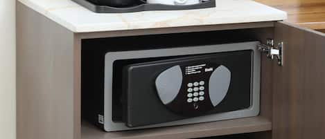 A compact kitchen with a coffee maker, a microwave, and a mini-fridge.