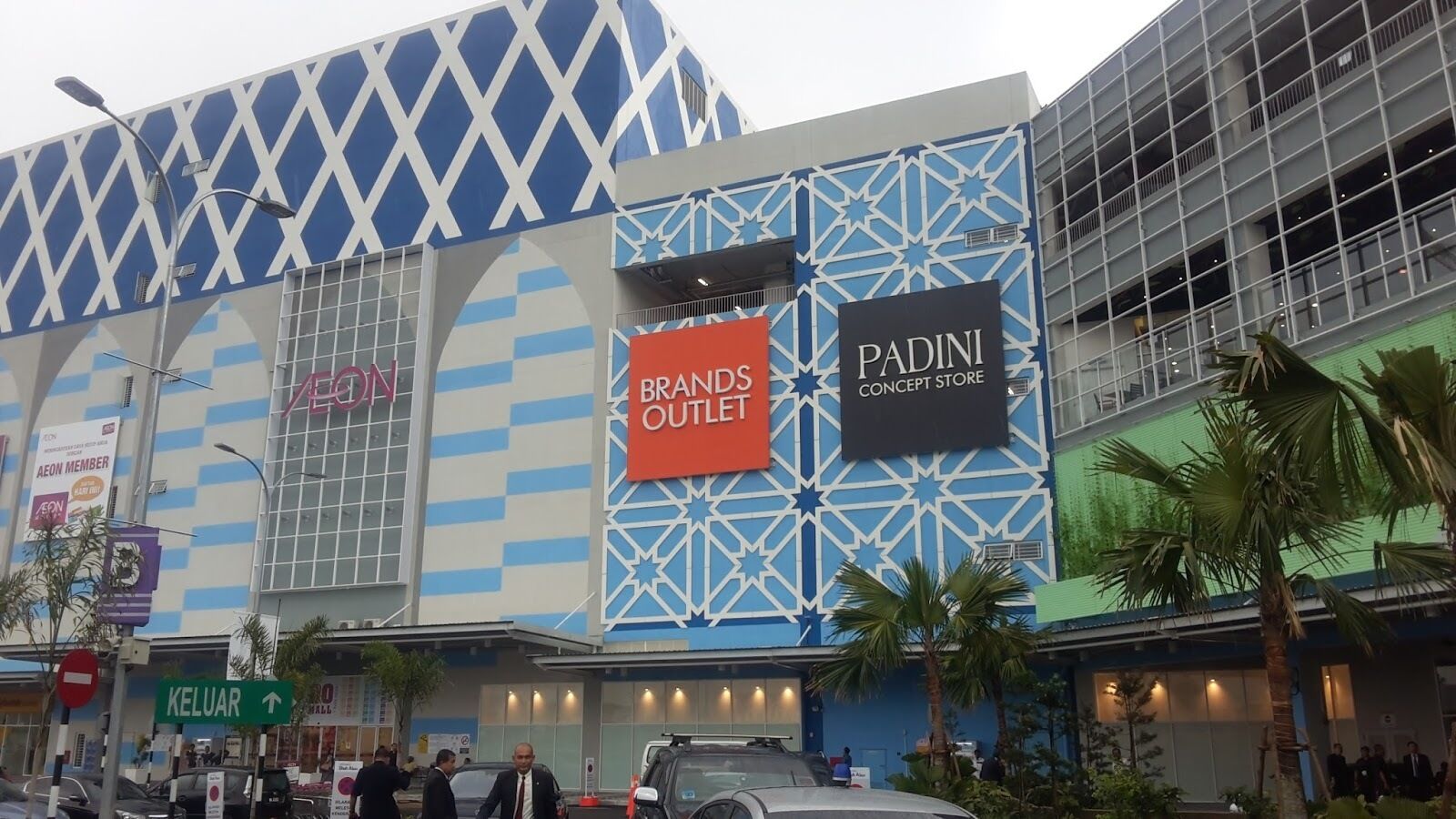 A modern building with a geometric facade, featuring the 'AEON' and 'BRANDS OUTLET' signs, and a 'PADINI CONCEPT STORE'.