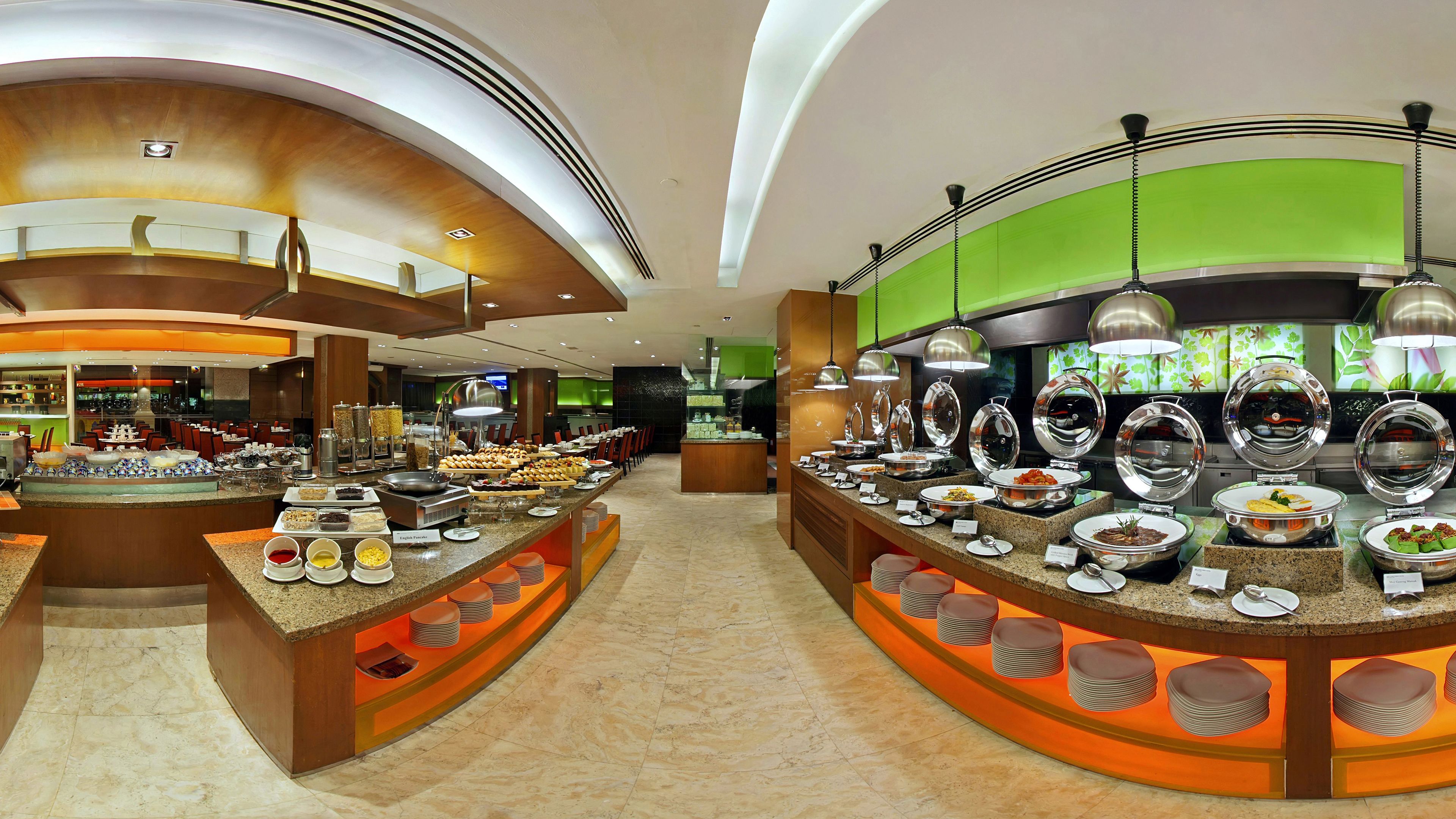 A buffet setup with multiple food stations, a bar area, and seating arrangements.