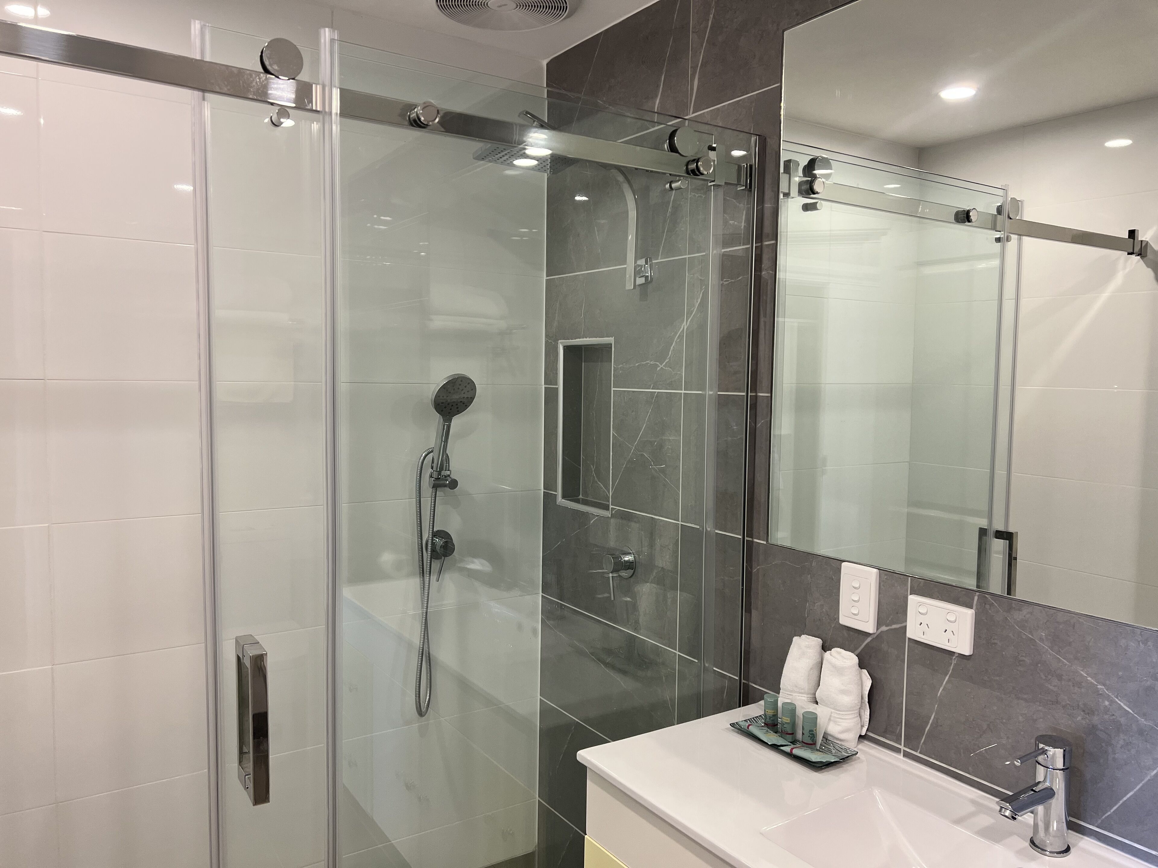 twin room (corporate) | bathroom | shower, designer toiletries, hair dryer, towels