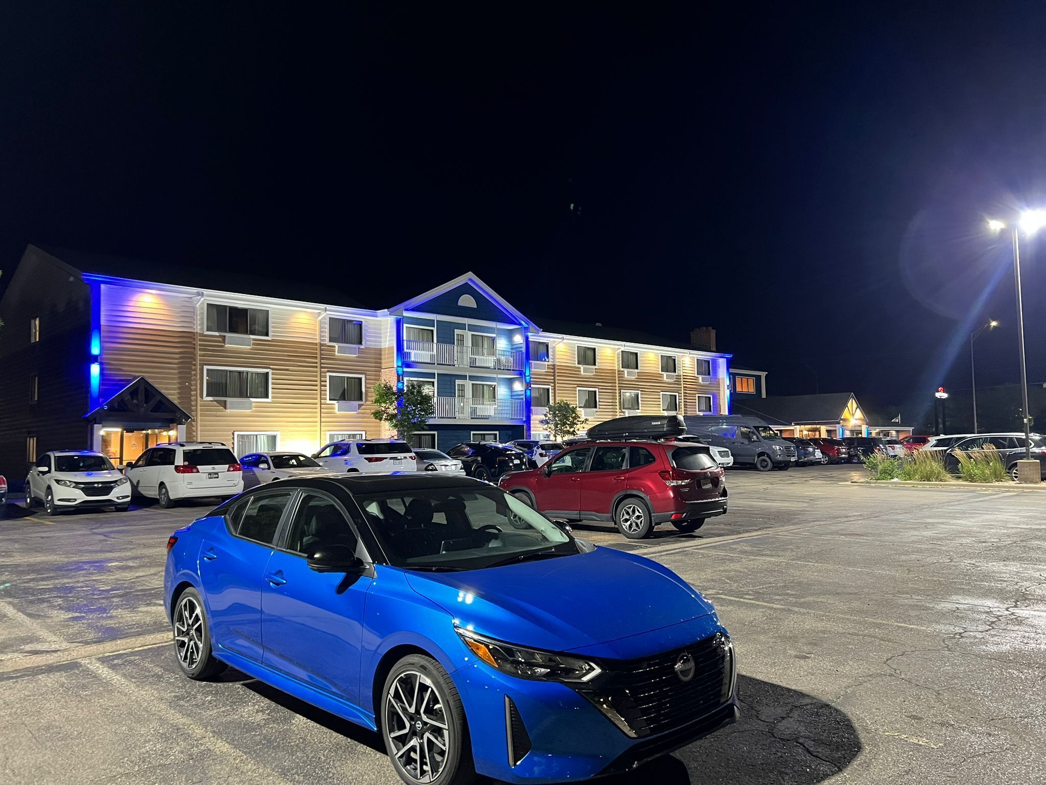 A multi-story hotel with a parking lot.