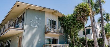 A two-story building with balconies, labeled "INN AT EAST BEACH."