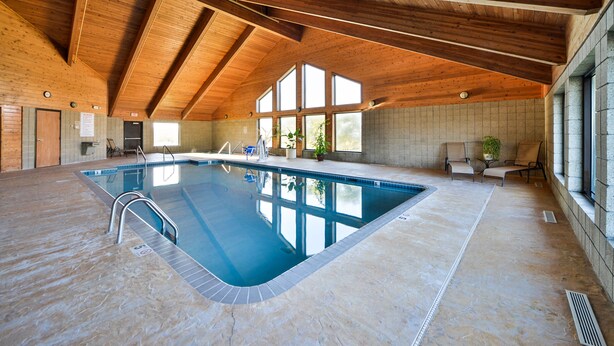 An indoor swimming pool with a wooden ceiling and large windows. - Best Western Germantown Inn (Village of Germantown)