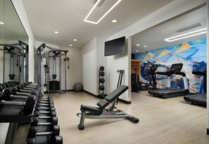 A gym with exercise equipment, a bench press, treadmills, and a colorful mural. - HYATT house San Diego/Sorrento Mesa (San Diego)