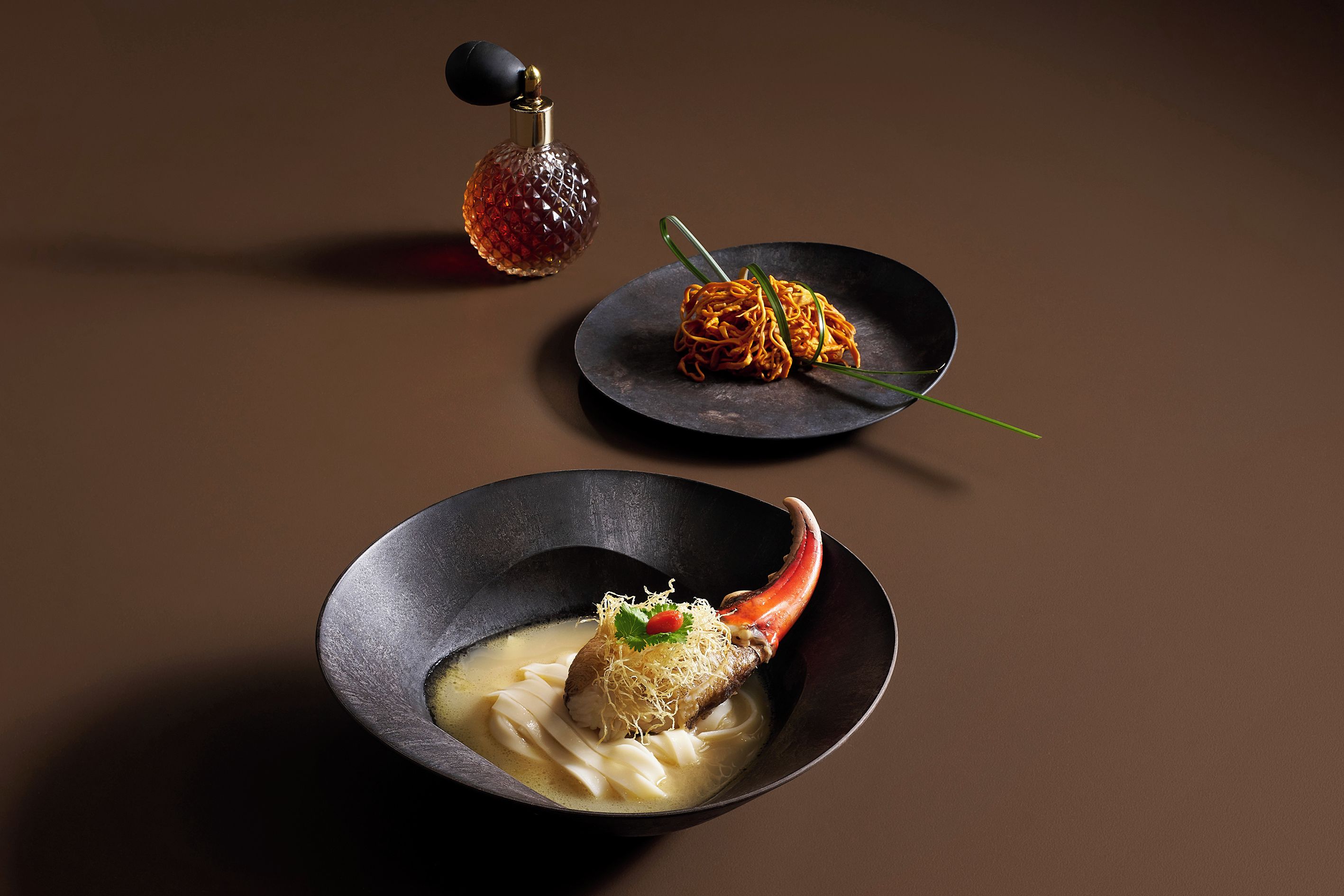 Three dishes on a dark surface.