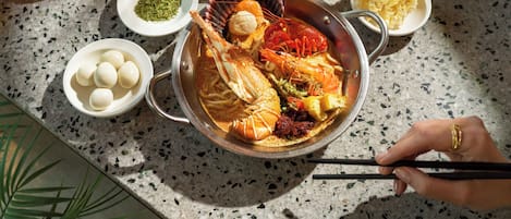 A seafood dish with various accompaniments on a table.