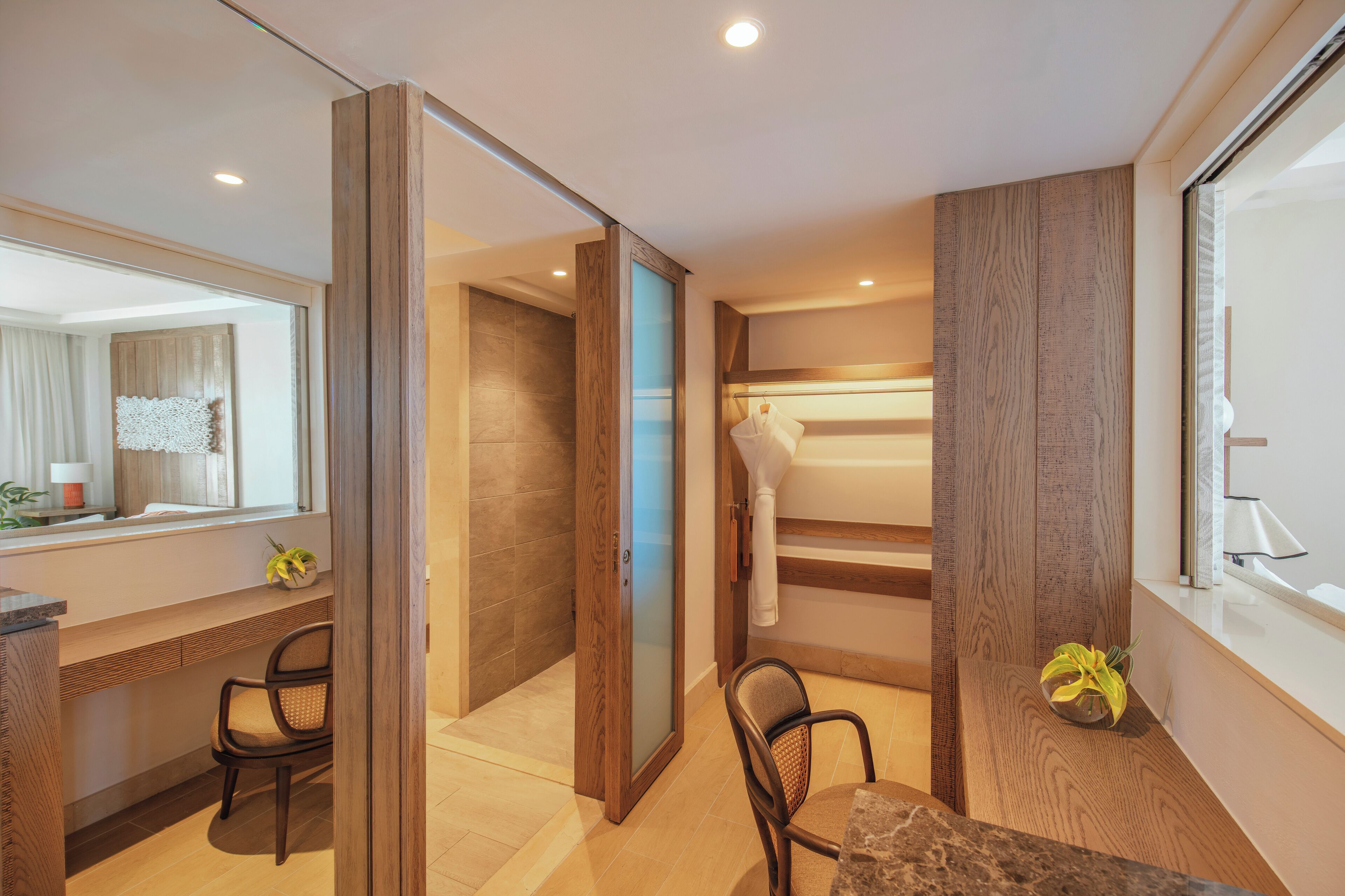 A modern bathroom with a shower, a mirror, and a towel rack.