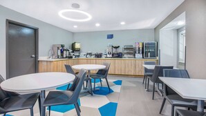 A modern kitchen area with a coffee machine, a refrigerator, and a microwave. - Microtel Inn by Wyndham Beckley (Beckley)