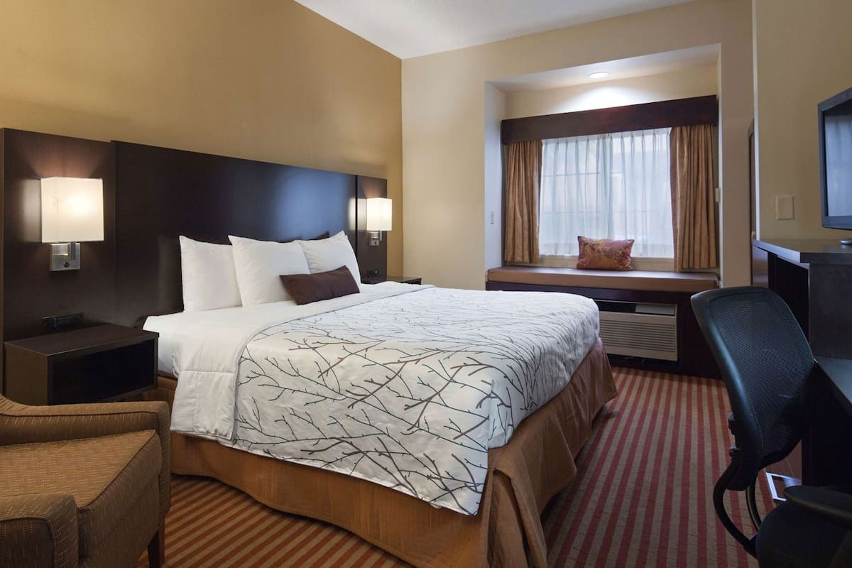 Premium bedding, desk, laptop workspace, iron/ironing board