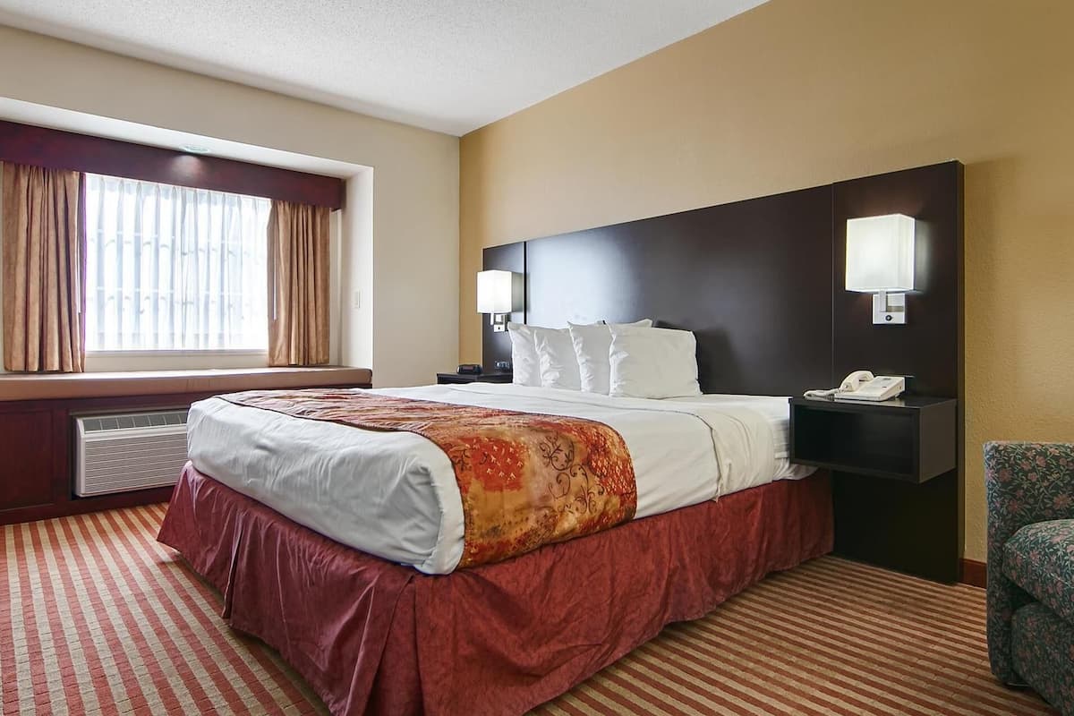 Premium bedding, desk, laptop workspace, iron/ironing board