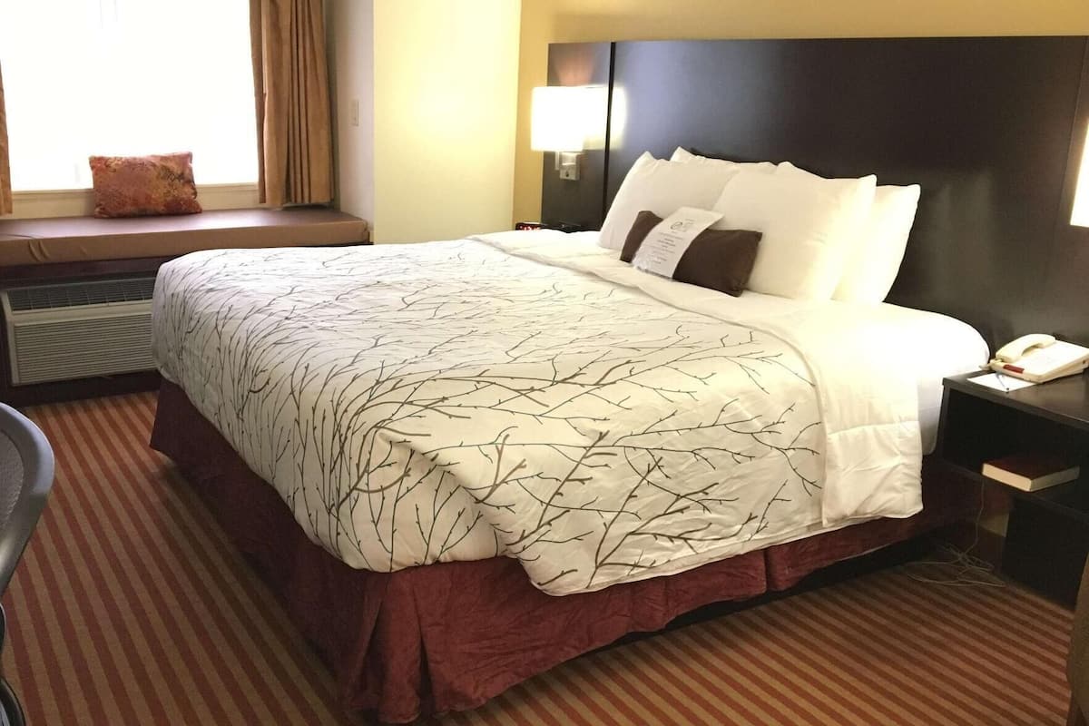 Premium bedding, desk, laptop workspace, iron/ironing board