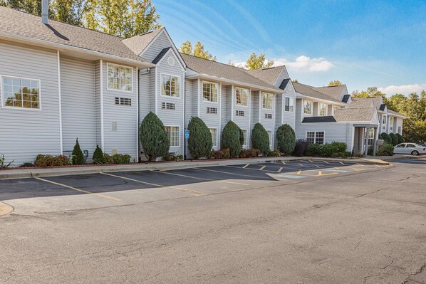 Guests can park their vehicles in designated spaces in front of the buildings.