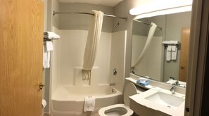 A bathroom with a bathtub, a toilet, a sink, and a shower with a curtain. - Microtel Inn & Suites by Wyndham Philadelphia Airport (Philadelphia)