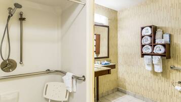 A bathroom with a shower, toilet, and sink.