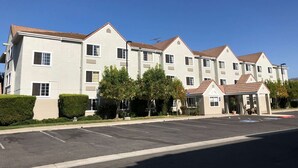 A multi-story hotel with a symmetrical facade, large windows, and a covered entrance area. - Microtel Inn & Suites by Wyndham Morgan Hill/San Jose Area (Morgan Hill)