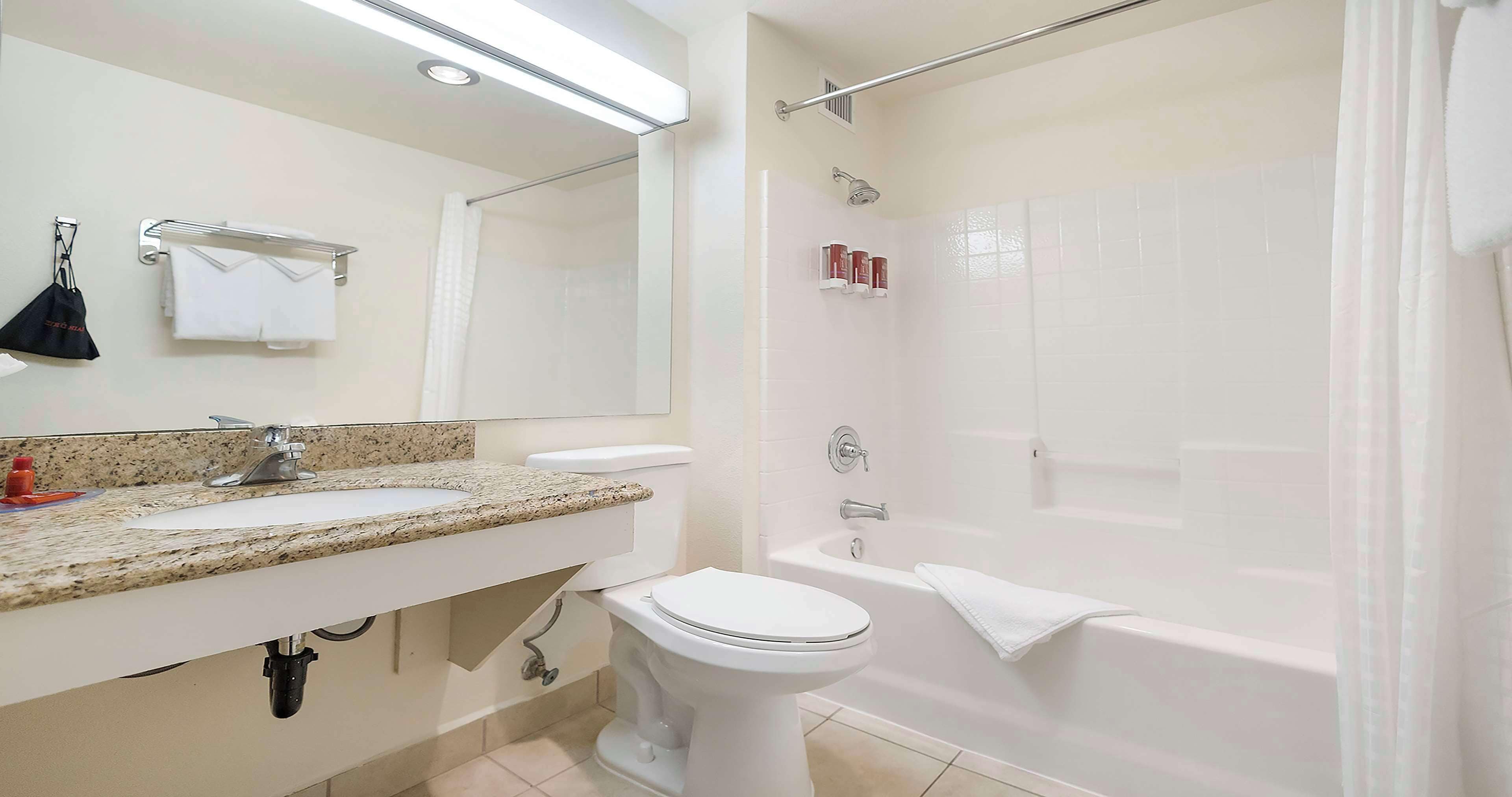 A bathroom with a sink, toilet, and bathtub.