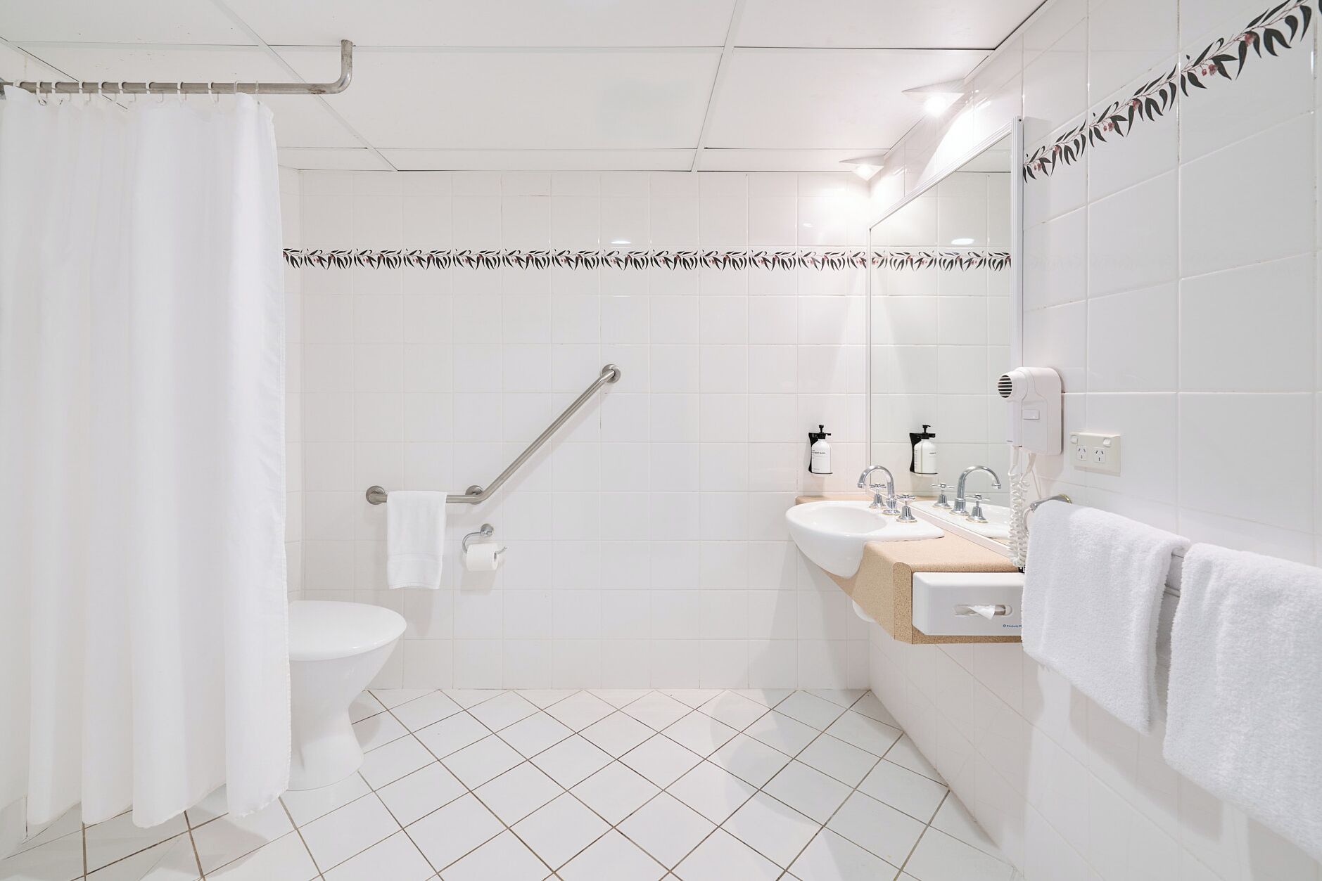 A modern bathroom with a toilet, bidet, and sink.