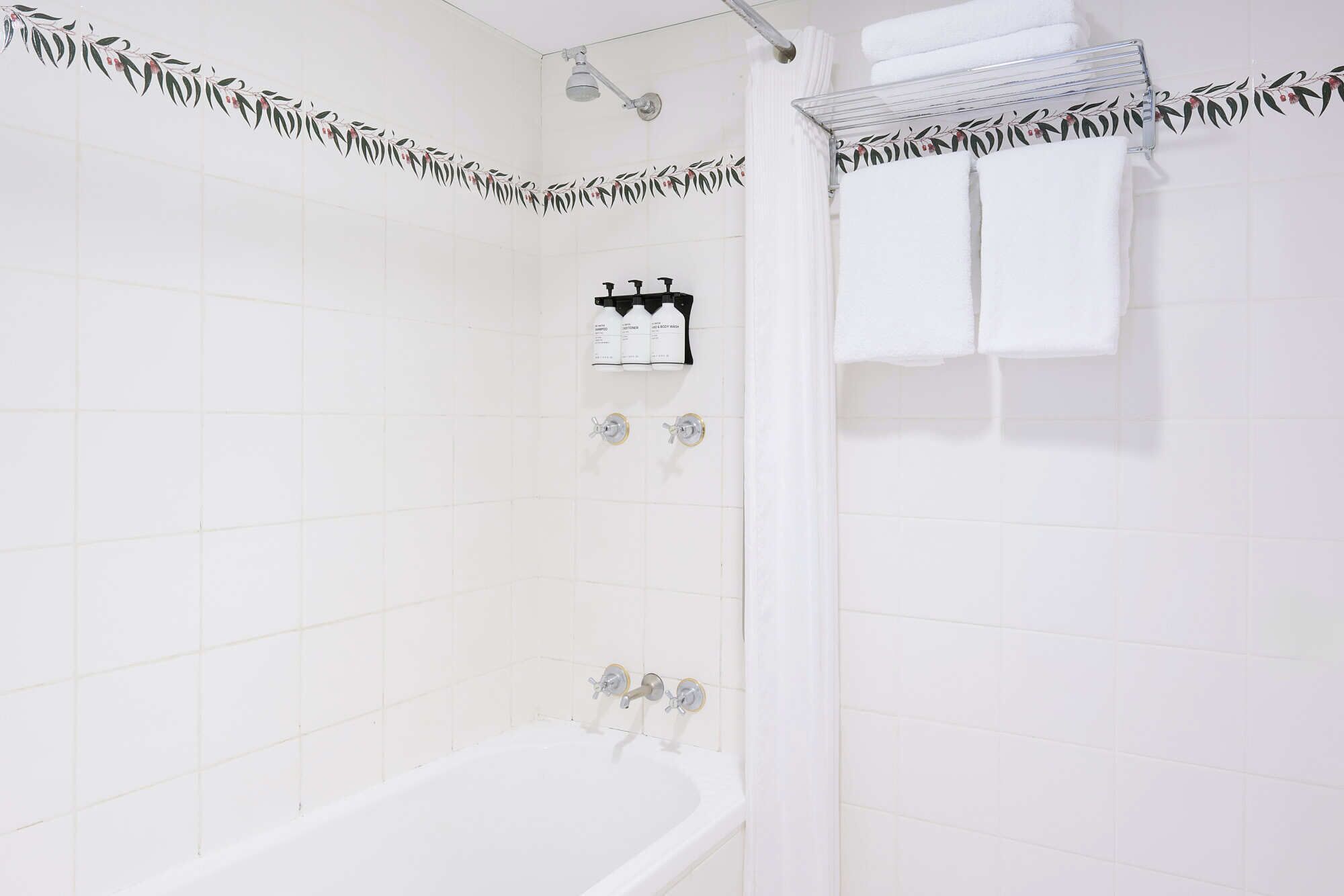 Une salle de bain avec une baignoire, une douche et un porte-serviettes.