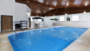 An indoor swimming pool with clear lanes, a wooden ceiling, and a clock on the wall. - Baymont by Wyndham Auburn (Auburn)