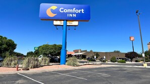 A Comfort Inn sign with a clear view of the parking lot and surrounding buildings. - Comfort Inn Gallup I-40 Exit 20 (Gallup)