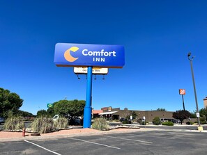 A Comfort Inn sign with a clear view of the parking lot and surrounding buildings. - Comfort Inn Gallup I-40 Exit 20 (Gallup)