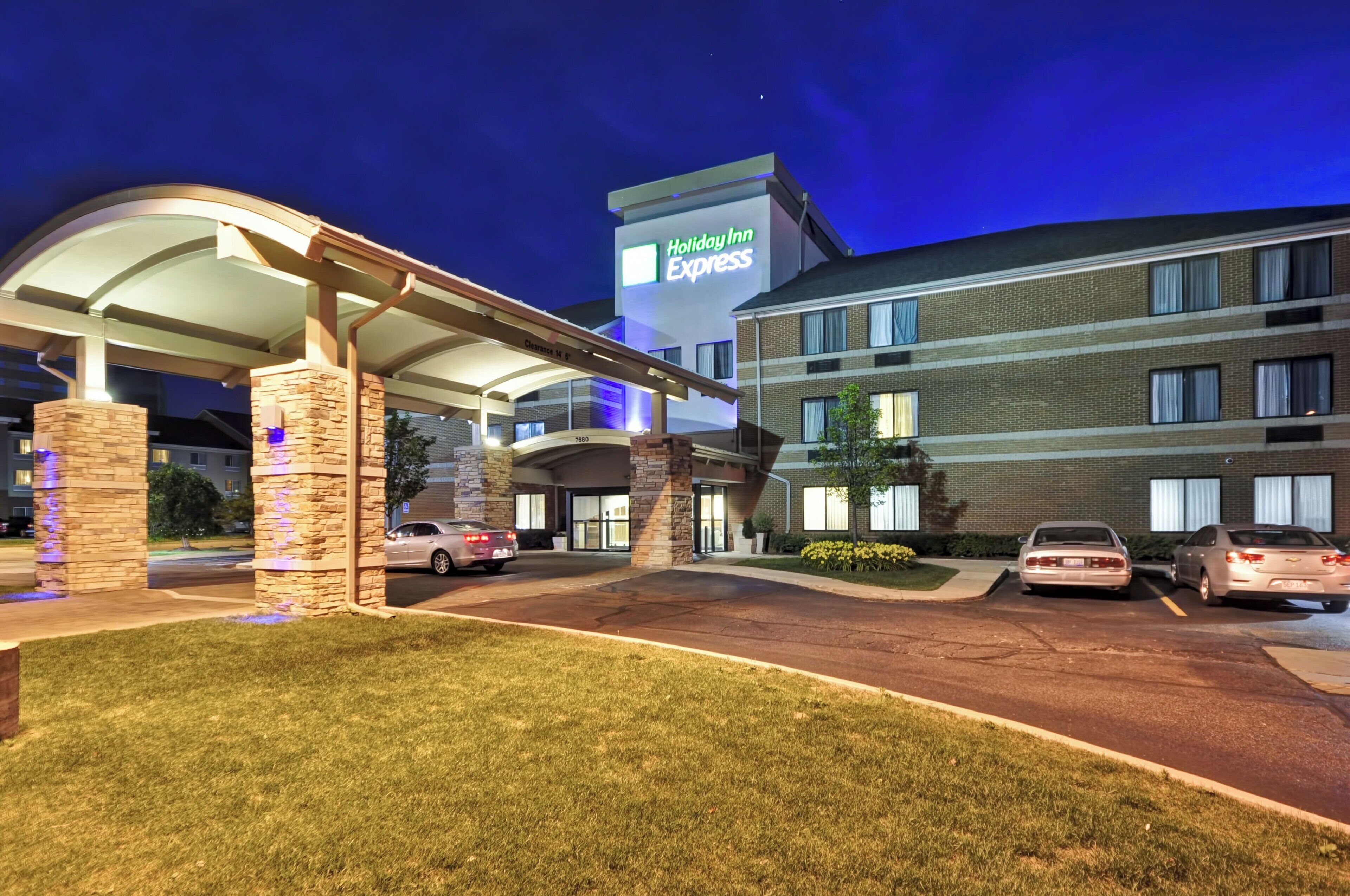 A Holiday Inn Express hotel with a covered parking area and a brick facade.